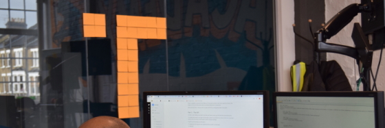 Learner with T made of post-its behind them